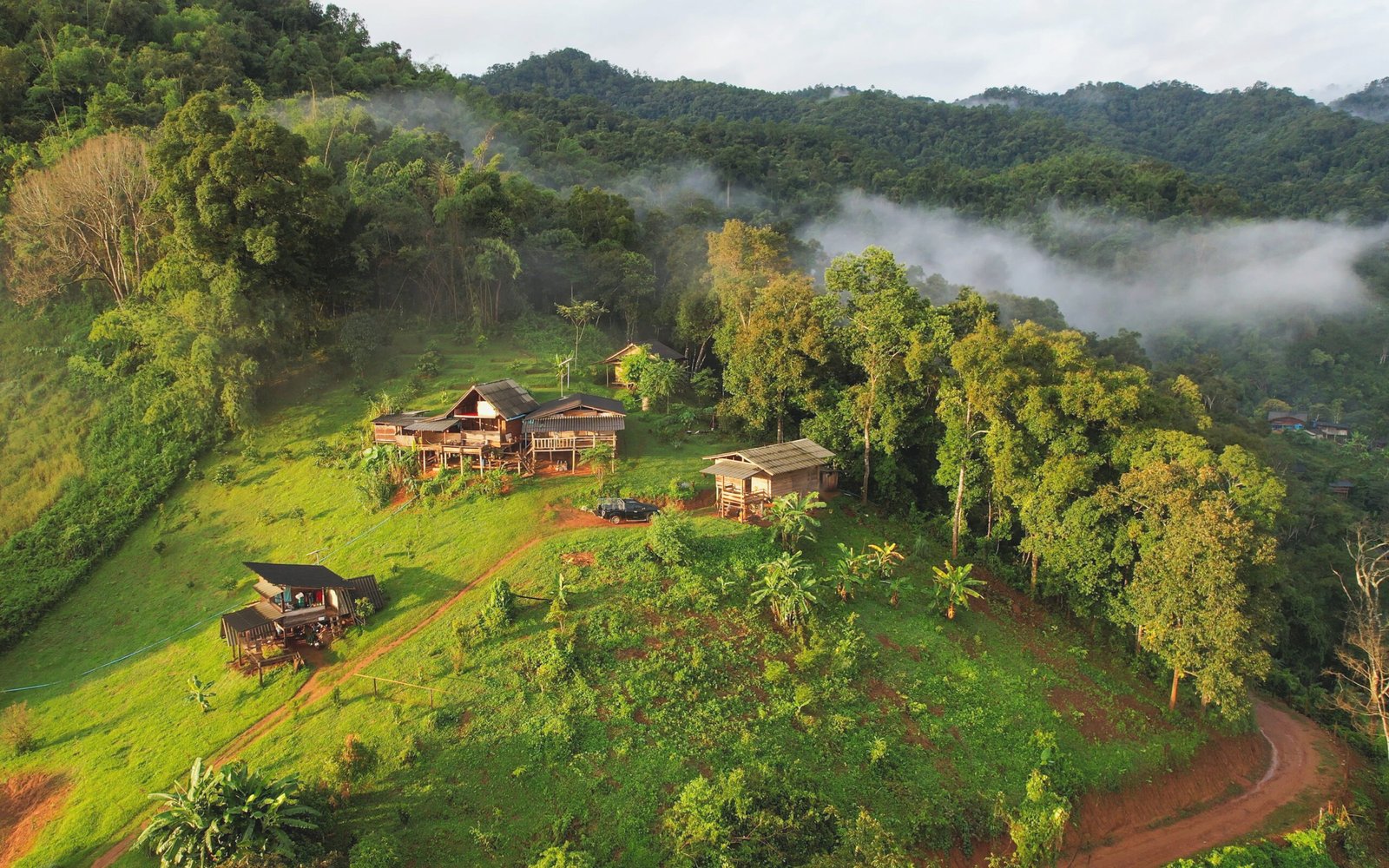 Aerial view from drone of the rural village in the mountains on foggy day